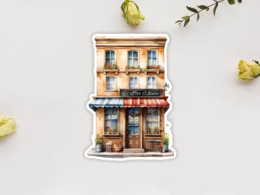 Preview: 8 Café Shop Sticker Set – Charmante kleine Cafés und Geschäfte Preview: Sticker mit einer charmanten Kaffeehaus-Fassade im mediterranen Stil, mit blauen Fenstern, Blumenkästen und einer rot-blau gestreiften Markise. Vor dem Eingang stehen Tische und Pflanzen, die eine gemütliche Atmosphäre schaffen.